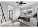 Comfortable bedroom with natural light, ceiling fan, and an ensuite bathroom at 3898 Descent St, Castle Rock, CO 80108