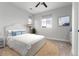 Light and airy bedroom showcasing neutral decor, natural textures and light-filled windows at 3898 Descent St, Castle Rock, CO 80108