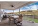 Inviting covered patio with a dining table, chairs, and scenic views of the surrounding landscape at 3898 Descent St, Castle Rock, CO 80108