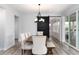 Dining area with elegant seating, modern lighting, and a decorative sliding barn door at 3898 Descent St, Castle Rock, CO 80108