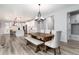 Bright dining area showcasing a rustic wooden table set and stylish light fixture at 3898 Descent St, Castle Rock, CO 80108