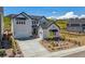 Charming two-story white home with a well-manicured front yard and a spacious driveway under a bright, sunny sky at 3898 Descent St, Castle Rock, CO 80108