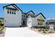 Beautiful modern farmhouse with white siding, black trim, and a well-manicured front yard at 3898 Descent St, Castle Rock, CO 80108