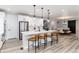 Open-concept kitchen with a large island, stainless steel appliances, and modern white cabinetry at 3898 Descent St, Castle Rock, CO 80108