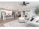 Spacious open-concept living room and kitchen with hardwood floors and large windows for natural light at 3898 Descent St, Castle Rock, CO 80108