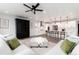 Open-concept space with a kitchen island and a cozy living area with plush sofas and a large rug at 3898 Descent St, Castle Rock, CO 80108