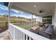 Covered patio with a ceiling fan and outdoor seating with views of green spaces and neighborhood at 3898 Descent St, Castle Rock, CO 80108