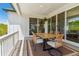 Covered patio with an outdoor dining table and views into the house through sliding glass doors at 3898 Descent St, Castle Rock, CO 80108