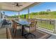 Inviting covered patio with outdoor dining set and scenic views of the green landscape and play area at 3898 Descent St, Castle Rock, CO 80108