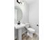 Simple powder room with a pedestal sink, toilet, and modern fixtures at 3898 Descent St, Castle Rock, CO 80108