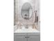 Bathroom vanity with white cabinets, modern fixtures, and decorative mirror at 424 N Clarkson St, Denver, CO 80218