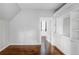 Bright bedroom featuring hardwood floors, built-in shelving, and an open doorway to another room at 424 N Clarkson St, Denver, CO 80218