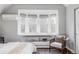 Inviting bedroom featuring a comfortable chair, bay windows, and hardwood floors at 424 N Clarkson St, Denver, CO 80218