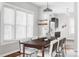 Dining room with ample sunlight, modern lighting fixture, hardwood floors, and seating for eight at 424 N Clarkson St, Denver, CO 80218