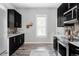 Kitchen with stainless steel appliances, dark cabinets, and mosaic tile backsplash at 424 N Clarkson St, Denver, CO 80218