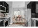 Kitchen with stainless steel appliances, dark cabinets, and an open floor plan at 424 N Clarkson St, Denver, CO 80218