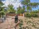 This backyard features a shed, patio area, and mature trees at 6160 Taft Ct, Arvada, CO 80004
