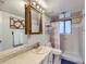 Functional bathroom features a shower with curtain, white tile walls, and a marble countertop sink at 6160 Taft Ct, Arvada, CO 80004