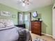 Comfortable bedroom with a ceiling fan, complemented by natural light streaming through the window at 6160 Taft Ct, Arvada, CO 80004