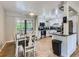 Well-lit dining room and kitchen with modern appliances, white cabinets and dining table at 6160 Taft Ct, Arvada, CO 80004
