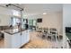 Open-concept living room and dining area featuring hardwood floors and a ceiling fan at 6160 Taft Ct, Arvada, CO 80004