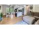 Open concept living space with hardwood floors, kitchen with island, and cozy living room at 6160 Taft Ct, Arvada, CO 80004