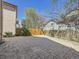 Spacious backyard with large patio area, wood fence, and mature trees at 2216 S Nile Ct, Aurora, CO 80014