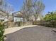 Spacious backyard with large patio area, wood fence, and mature trees at 2216 S Nile Ct, Aurora, CO 80014