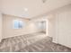 Finished basement area with neutral carpet, windows, and access to the upper floors at 2216 S Nile Ct, Aurora, CO 80014