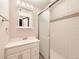 Bathroom with white vanity, tiled shower, and modern mirror at 2216 S Nile Ct, Aurora, CO 80014