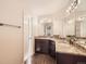 Bathroom showcasing dual sinks, granite counters, decorative mirrors, and modern fixtures at 2216 S Nile Ct, Aurora, CO 80014