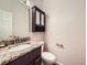 Updated powder room with granite vanity, vessel sink, modern faucet, and custom framed mirror at 2216 S Nile Ct, Aurora, CO 80014