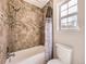Stylish bathroom features tub, shower with tiled walls, modern fixtures, and ample natural light at 2216 S Nile Ct, Aurora, CO 80014