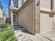 Exterior of home with brick accents, well kept lawn, and front door with direct access to garage at 2216 S Nile Ct, Aurora, CO 80014