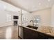Bright open floor plan with updated kitchen island featuring granite countertops and modern fixtures at 2216 S Nile Ct, Aurora, CO 80014