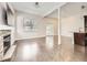 Bright, open living room featuring hardwood floors, fireplace, large windows, and seamless transition to the kitchen at 2216 S Nile Ct, Aurora, CO 80014