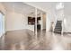 Bright open concept living space featuring staircase, kitchen, and large format hardwood flooring at 2216 S Nile Ct, Aurora, CO 80014