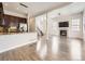 Open concept living space connecting modern kitchen to living room with fireplace and stairway to second floor at 2216 S Nile Ct, Aurora, CO 80014