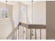 Bright staircase landing with decorative chandeliers and natural light from large windows at 2216 S Nile Ct, Aurora, CO 80014
