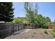 Large backyard featuring mountain views, a wood fence, rock landscaping and mature trees at 800 Park View Pl, Castle Rock, CO 80104
