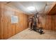 Finished basement features an exercise machine and wood paneled walls, offering space for recreation at 800 Park View Pl, Castle Rock, CO 80104