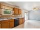 This kitchen features light-colored wood cabinets and a tile backsplash at 800 Park View Pl, Castle Rock, CO 80104