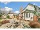 Spacious backyard with stone fire pit, mature landscaping, and a view of the home's architecture at 12258 E Lasalle Pl, Aurora, CO 80014