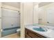 Bathroom featuring a blue tub, toilet, sink and neutral colored walls and tile at 12258 E Lasalle Pl, Aurora, CO 80014