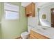 Bathroom featuring a wooden vanity, a sink, and a window at 12258 E Lasalle Pl, Aurora, CO 80014