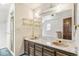 Bathroom featuring double sinks, vanity with drawers, and a shower behind glass doors at 12258 E Lasalle Pl, Aurora, CO 80014