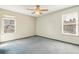 Bedroom with two large windows providing natural light and blue carpet at 12258 E Lasalle Pl, Aurora, CO 80014