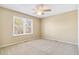 Bright bedroom with a ceiling fan, neutral walls, and a large window with natural light at 12258 E Lasalle Pl, Aurora, CO 80014