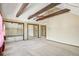 Bedroom with vaulted ceilings with exposed beams, carpet flooring, and mirrored closet doors at 12258 E Lasalle Pl, Aurora, CO 80014