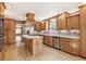 Open kitchen with wooden cabinets, stainless steel appliances, and a center island at 12258 E Lasalle Pl, Aurora, CO 80014